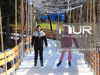 People ice skate in Ice Park Sofia at Knyazheska Garden in Sofia, Bulgaria, on December 9, 2024. (