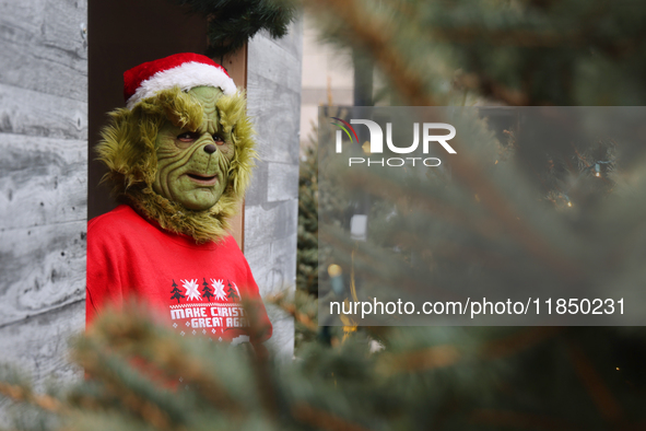 A man dressed as the Grinch greets children at the Toronto Christmas market in Toronto, Ontario, Canada, on December 8, 2024. 