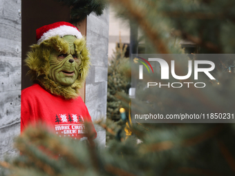 A man dressed as the Grinch greets children at the Toronto Christmas market in Toronto, Ontario, Canada, on December 8, 2024. (