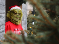 A man dressed as the Grinch greets children at the Toronto Christmas market in Toronto, Ontario, Canada, on December 8, 2024. (