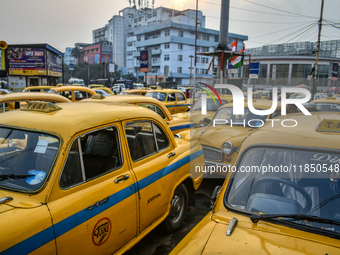 Yellow taxis stand near Sealdah railway station in Kolkata. (