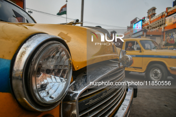 A yellow taxi bonnet is locked with a padlock near Sealdah railway station in Kolkata, India. 