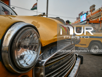 A yellow taxi bonnet is locked with a padlock near Sealdah railway station in Kolkata, India. (