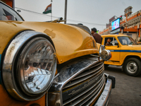 A yellow taxi bonnet is locked with a padlock near Sealdah railway station in Kolkata, India. (