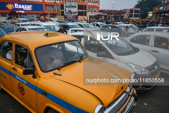 A yellow taxi is amid other commercial cabs in heavy traffic near Sealdah station in Kolkata. 