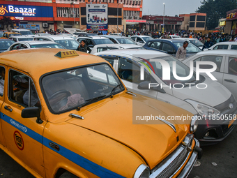 A yellow taxi is amid other commercial cabs in heavy traffic near Sealdah station in Kolkata. (