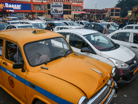 A yellow taxi is amid other commercial cabs in heavy traffic near Sealdah station in Kolkata. (