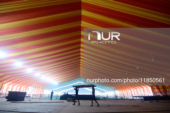 Workers apply the final touches to a temporary structure on the banks of Sangam, the confluence of the Rivers Ganges, Yamuna, and mythical S...