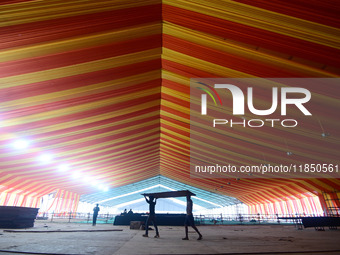 Workers apply the final touches to a temporary structure on the banks of Sangam, the confluence of the Rivers Ganges, Yamuna, and mythical S...