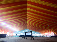 Workers apply the final touches to a temporary structure on the banks of Sangam, the confluence of the Rivers Ganges, Yamuna, and mythical S...