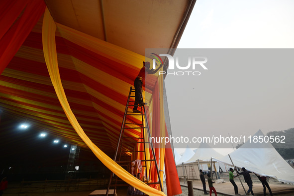 Workers apply the final touches to a temporary structure on the banks of Sangam, the confluence of the Rivers Ganges, Yamuna, and mythical S...