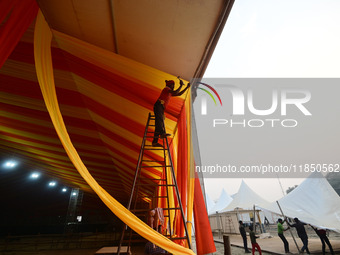 Workers apply the final touches to a temporary structure on the banks of Sangam, the confluence of the Rivers Ganges, Yamuna, and mythical S...