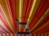 Workers apply the final touches to a temporary structure on the banks of Sangam, the confluence of the Rivers Ganges, Yamuna, and mythical S...