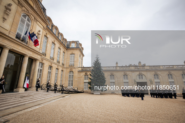 An illustration depicts the entrance to the presidential palace with the French Republican Guard in the courtyard of the Elysee Palace in Pa...