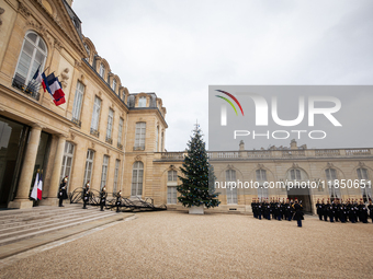 An illustration depicts the entrance to the presidential palace with the French Republican Guard in the courtyard of the Elysee Palace in Pa...