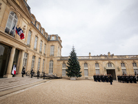 An illustration depicts the entrance to the presidential palace with the French Republican Guard in the courtyard of the Elysee Palace in Pa...