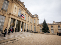 An illustration depicts the entrance to the presidential palace with the French Republican Guard in the courtyard of the Elysee Palace in Pa...