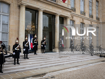 An illustration depicts the entrance to the presidential palace with the French Republican Guard in the courtyard of the Elysee Palace in Pa...