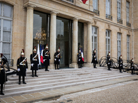 An illustration depicts the entrance to the presidential palace with the French Republican Guard in the courtyard of the Elysee Palace in Pa...