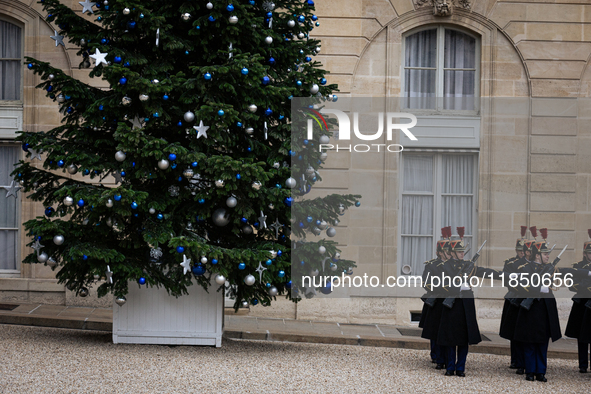 The French Republican Guard stands near the Christmas tree in the courtyard of the Elysee Palace in Paris, France, on September 12, 2024. 