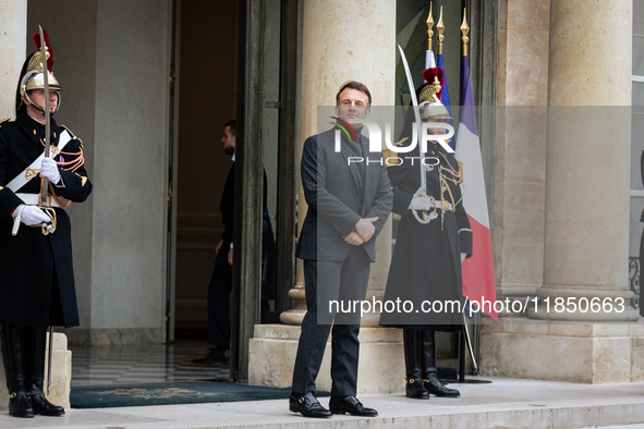 French President Emmanuel Macron stands at the entrance of the Elysee Palace before meeting with the President of Guinea-Bissau, Umaro Sisso...