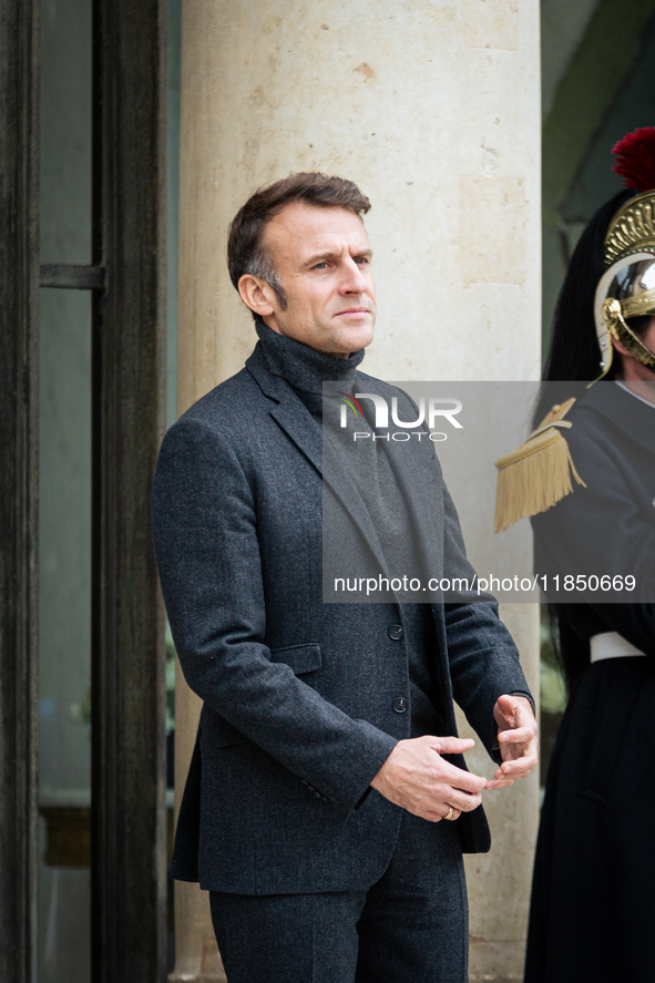 French President Emmanuel Macron stands at the entrance of the Elysee Palace before meeting with the President of Guinea-Bissau, Umaro Sisso...