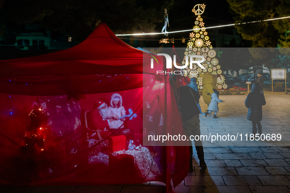 A Christmas tree and Santa's little house are in the Municipal Villa of Ruvo di Puglia, Italy, on December 8, 2024. The courses and streets...