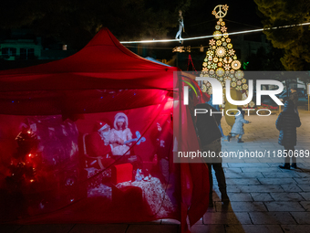 A Christmas tree and Santa's little house are in the Municipal Villa of Ruvo di Puglia, Italy, on December 8, 2024. The courses and streets...