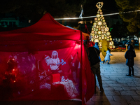 A Christmas tree and Santa's little house are in the Municipal Villa of Ruvo di Puglia, Italy, on December 8, 2024. The courses and streets...