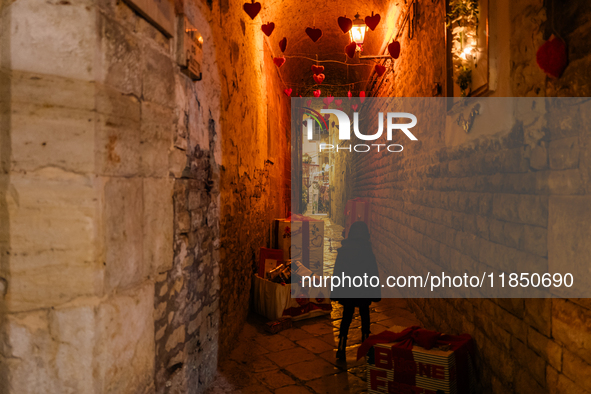 A street in the historic center of Ruvo di Puglia, Italy, on December 8, 2024, displays Christmas decorations. The courses and streets of Ru...