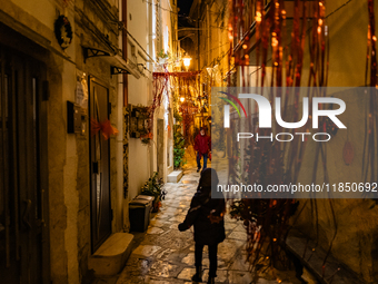 A street in the historic center of Ruvo di Puglia, Italy, on December 8, 2024, displays Christmas decorations. The courses and streets of Ru...