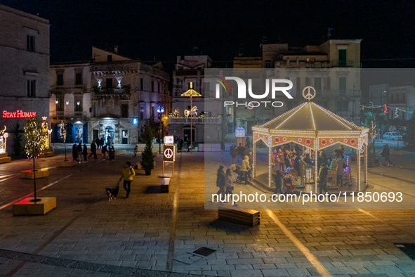 Carousel and artist lights are in Giacomo Matteotti Square in Ruvo di Puglia, Italy, on December 8, 2024. Courses and streets of Ruvo di Pug...