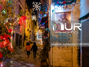 A street in the historic center of Ruvo di Puglia, Italy, on December 8, 2024, displays Christmas decorations. The courses and streets of Ru...