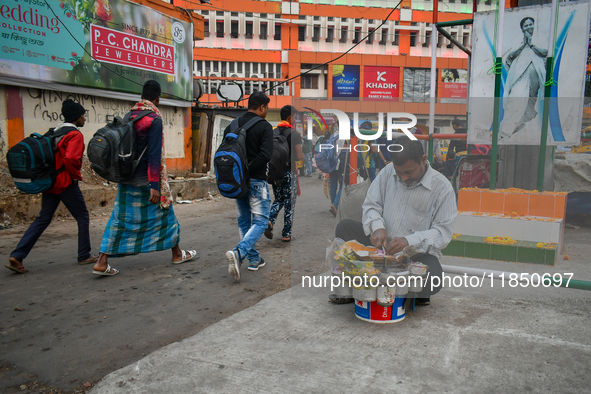 A street vendor prepares before starting the day's business near Sealdah Railway station. 