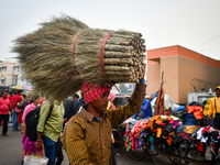 A laborer carries brooms near Sealdah Railway station. (