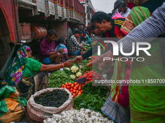 A vegetable seller sells vegetables at Koley market in Kolkata, one of the largest vegetable wholesale markets in South East Asia. (