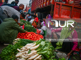 A vegetable seller sells vegetables at Koley market in Kolkata, one of the largest vegetable wholesale markets in Southeast Asia. (