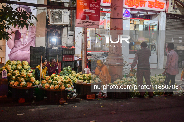 A vegetable seller sells cauliflower at a roadside shop in Kolkata. 