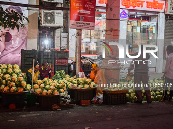 A vegetable seller sells cauliflower at a roadside shop in Kolkata. (