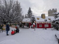 People interact at one of the entrances to a Christmas village in Akureyri, Iceland, on November 30, 2024. Christmas in Iceland, known as Jo...