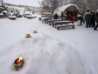 People interact at one of the entrances to a Christmas village in Akureyri, Iceland, on November 30, 2024. Christmas in Iceland, known as Jo...