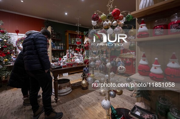 Several people look at decorations at a Christmas market in the town of Akureyri, Iceland, on November 30, 2024. Christmas in Iceland, known...