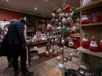 Several people look at decorations at a Christmas market in the town of Akureyri, Iceland, on November 30, 2024. Christmas in Iceland, known...