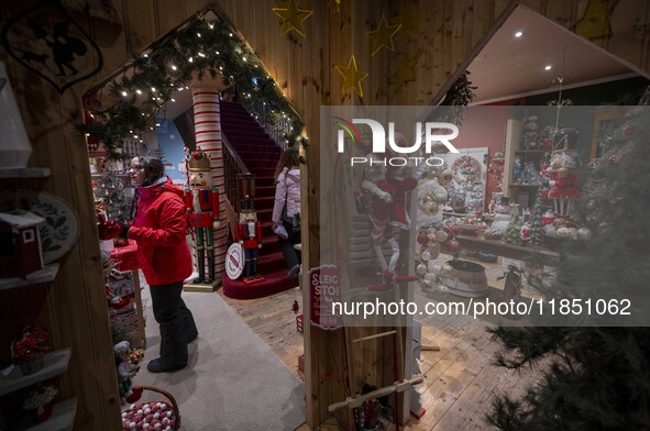 A person looks at decorations at a Christmas market in the town of Akureyri, Iceland, on November 30, 2024. Christmas in Iceland, known as J...