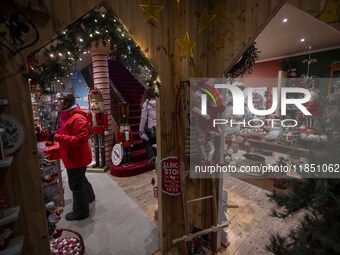 A person looks at decorations at a Christmas market in the town of Akureyri, Iceland, on November 30, 2024. Christmas in Iceland, known as J...