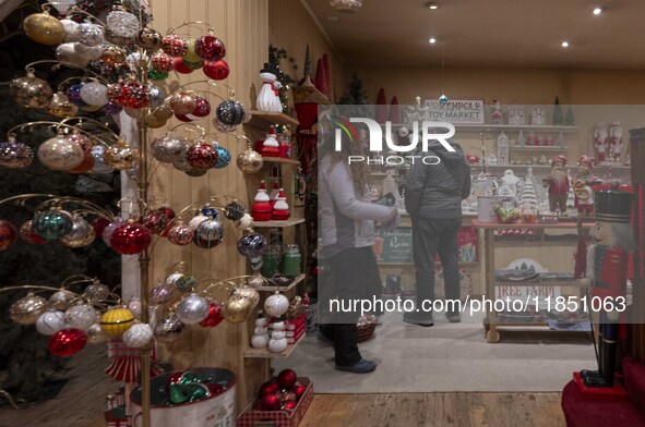 Several people look at decorations at a Christmas market in the town of Akureyri, Iceland, on November 30, 2024. Christmas in Iceland, known...