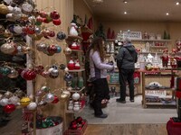 Several people look at decorations at a Christmas market in the town of Akureyri, Iceland, on November 30, 2024. Christmas in Iceland, known...