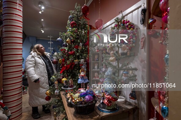 A person looks at decorations at a Christmas market in the town of Akureyri, Iceland, on November 30, 2024. Christmas in Iceland, known as J...