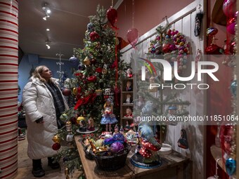 A person looks at decorations at a Christmas market in the town of Akureyri, Iceland, on November 30, 2024. Christmas in Iceland, known as J...