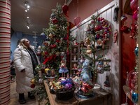 A person looks at decorations at a Christmas market in the town of Akureyri, Iceland, on November 30, 2024. Christmas in Iceland, known as J...